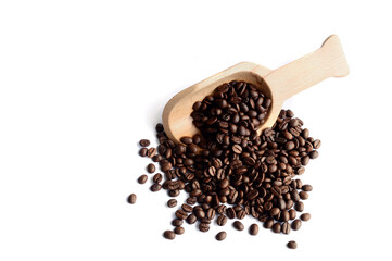 Fresh coffee beans in a wooden spoon.