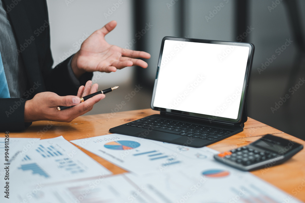 Poster professional presenting financial data using a digital tablet, surrounded by charts and a calculator