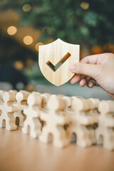 Shield icon and people model. Security protection and group  insurance. The concept of family home,...