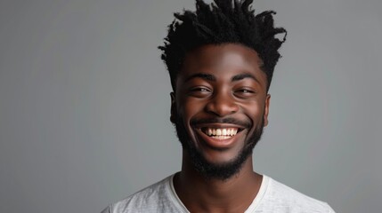 Obraz premium Smiling Man with Afro Hairstyle in White Shirt on Gray Background - Happy and Confident Expression