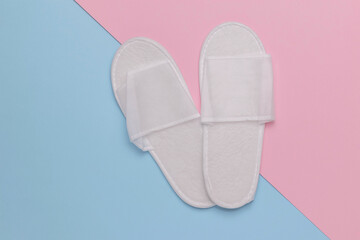 Minimalist White Slippers on Pastel Pink and Blue Background - Spa, Wellness, Comfort