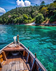 Obraz premium Wooden boat floating on clear turquoise water.