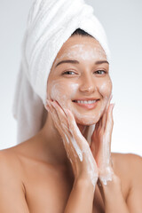 Smiling Woman Washing Face with Foam, Towel Wrapped Hair, Skincare Routine