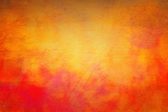 Orange background, fall or autumn background colors of red yellow and orange, background texture for halloween or thanksgiving design