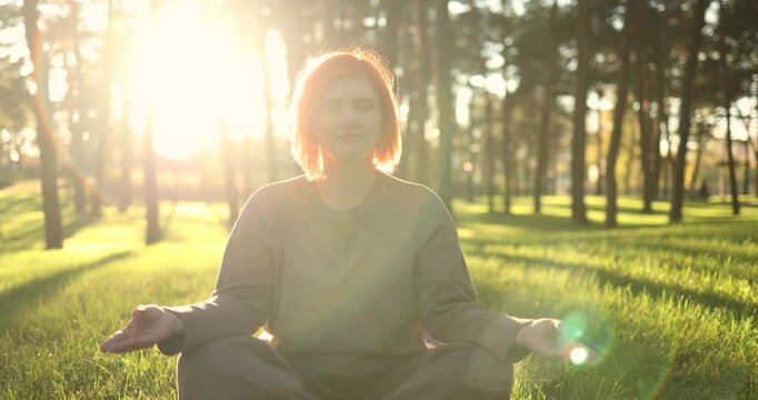 A tranquil scene shows a person meditating in nature at sunset, promoting inner peace and mindfulness