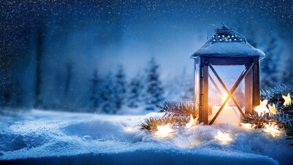 Lantern on the background of the winter forest. Christmas background.