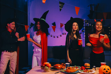 Joyful office Halloween party with coworkers in costumes, celebrating with drinks and laughter, fostering teamwork and festive spirit