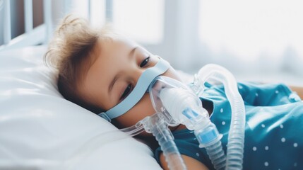 A young child lies on a bed with a breathing mask, receiving medical treatment, bathed in soft daylight from a nearby window.