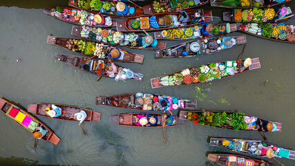 Aerial view Damnoen Saduak floating market, Farmer go to sell organic product, fruit, vegetable and Thai cuisine, Tourist visiting by boat, Ratchaburi, Thailand, Famous floating market in Thailand.
