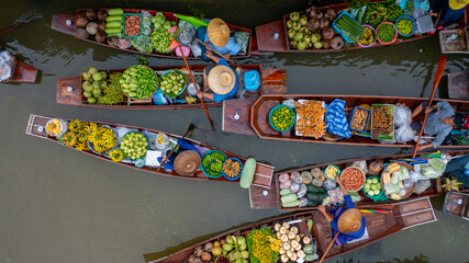 Aerial view Damnoen Saduak floating market, Farmer go to sell organic product, fruit, vegetable and Thai cuisine, Tourist visiting by boat, Ratchaburi, Thailand, Famous floating market in Thailand.