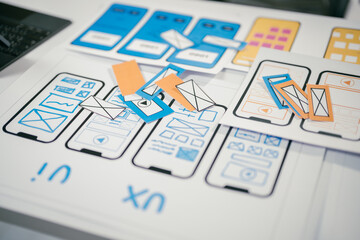 Ux designers are discussing during a meeting about user experience and user interface layout for...