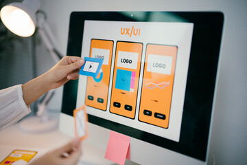 Female ux ui designer is working on a user experience for a mobile application, creating a...