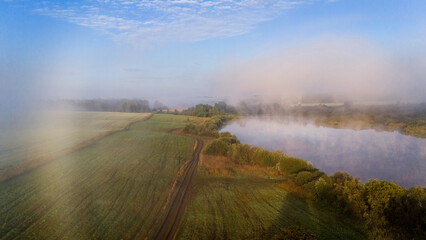 Fog rises from the lake at dawn