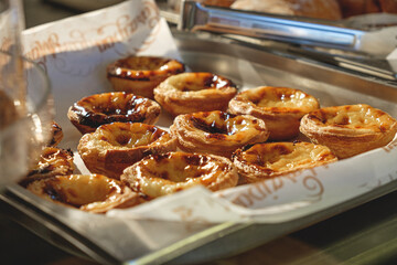 Fresh baked Pastel de nata or Pastel de belém .The most famous sweet in Portugal. Tart on baking sheet/