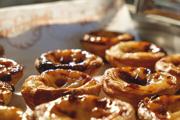 Fresh baked Pastel de nata or Pastel de belém .The most famous sweet in Portugal. Tart on baking...