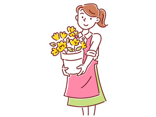 花が咲いた植木鉢を持った花屋の若い女性スタッフ