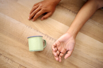 Top View Of Hand With Epileptic Seizures Lying on the Floor