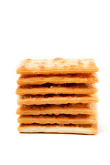 A stack of sweet crispy cracker sprinkled with sugar on top, set against a clean white background. The golden brown crackers create a simple yet appetizing display
