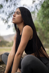 Fototapeta premium Lifestyle of young woman with straight hair and natural beauty, doing sports on a sunny day, lifestyle and wellness, physical activity, human body