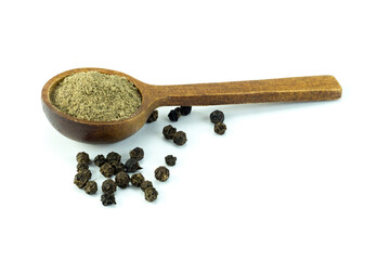 Ground black pepper in wooden spoon and whole grains isolated on white background closed up stacking. Herb and spice concept. 