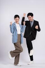 Image of an Asian business couple posing on a white background.