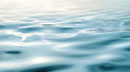 A serene view of gently rippling water reflecting soft light.