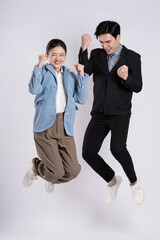 Image of an Asian business couple posing on a white background.