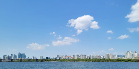 panorama view of the river, Yeouido Hangang River Park, in Seoul, Korea, with a broad bridge, and a cityscape in the backdrop	
