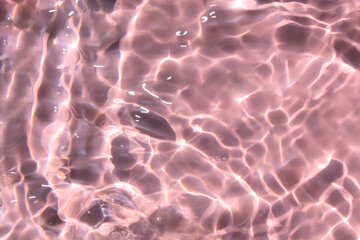 Pink water bubbles on the surface ripples. Defocus blurred transparent pink colored clear calm...