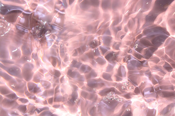 Pink water bubbles on the surface ripples. Defocus blurred transparent pink colored clear calm water surface texture with splash and bubbles. Water waves with shining pattern texture background