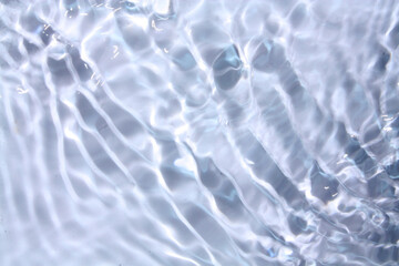 White water with ripples on the surface. Defocus blurred transparent white colored clear calm water surface texture with splashes and bubbles. Water waves with shining pattern texture background.