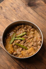 Sambal Goreng Krecek is a ground beef sambal with beef skin crackers, cooked with coconut milk, chili, and spices. Indonesian cuisine.