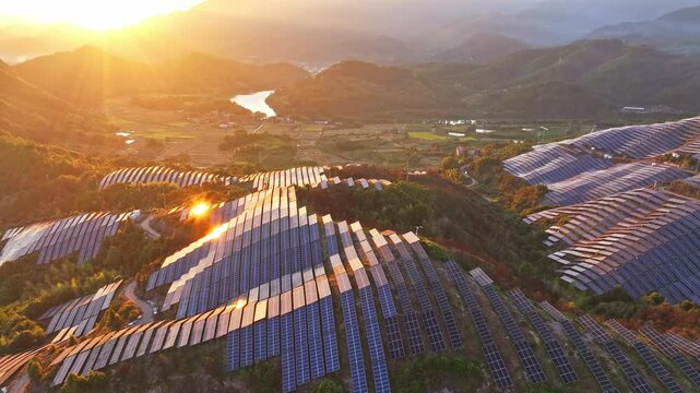 Aerial photography of solar photovoltaic panels，sunset over the mountains
