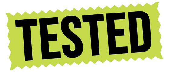 TESTED text written on green-black stamp sign.
