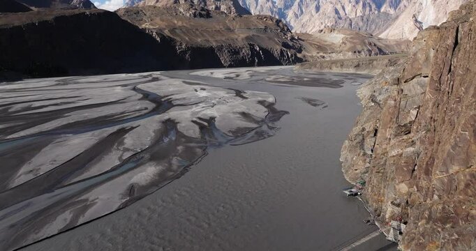 Aerial Pullback Reveals Hussaini Suspension Bridge, Hunza River, Pakistan. Passu Cones