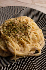 Carbonara is a pasta dish made with fatty cured pork, hard cheese, eggs, salt, and black pepper. It is typical of the Lazio region of Italy. .