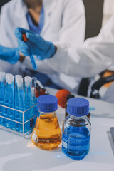 Scientist using microscope in laboratory. Close-up of a researcher's hands adjusting a modern...