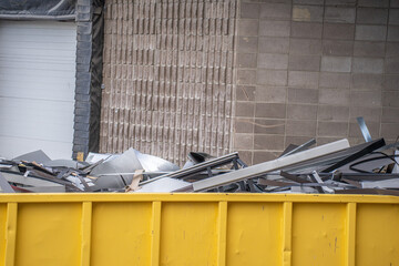 scrap metal steel in yellow recycle container
