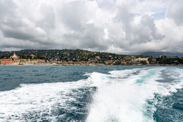 Small city near Portofino from the sea with dramatic sky
