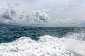 Fototapeta premium Small city near Portofino from the sea with dramatic sky