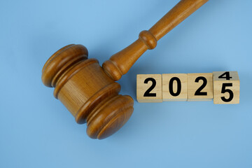Judge gavel and numbers 2025 on wooden cubes. Concept of new laws in year 2025.