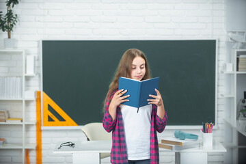 Back to school. School and students reading book in classroom. Education kids. Child pupil student...