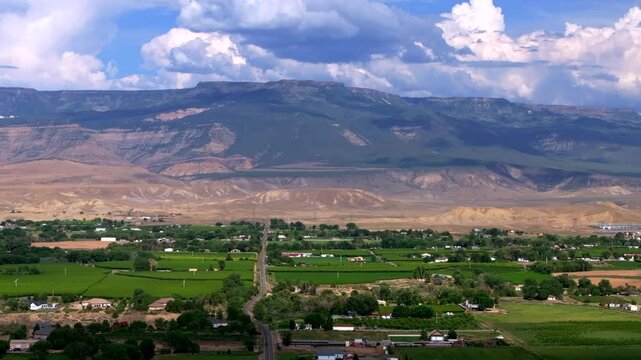 Grand Mesa Grand Junction aerial drone afternoon cloudy Colorado River summer blue sky wine vineyards Parachute Fruitvale Mt Garfield Western Close Delta downtown Main Street backwards motion
