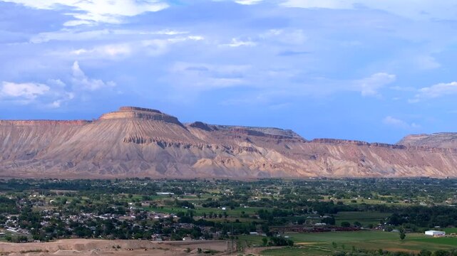 Grand Junction aerial drone afternoon cloudy Grand Mesa Colorado River summer blue sky wine vineyards Parachute Fruitvale Mt Garfield Western Close Delta downtown Main Street circle left motion