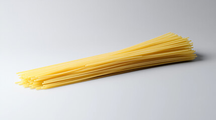 A bundle of uncooked spaghetti pasta on a light background ready for cooking at home