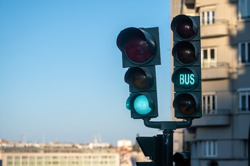 Green traffic light showing bus signal in an urban area during a clear day