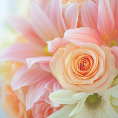 A bouquet of pink and white flowers with a yellow rose in the middle