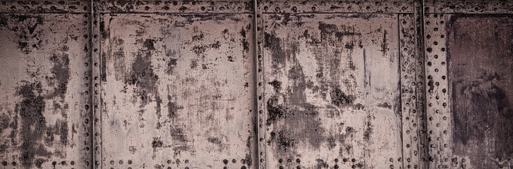Metal texture with rivets as steam punk. Worn steel texture or metal. Dark worn rusty metal texture background. Scratched and spotted rusty metal background.