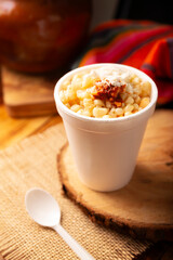 Esquites. Corn kernels cooked and served with mayo, sour cream, lemon and chili powder, very...