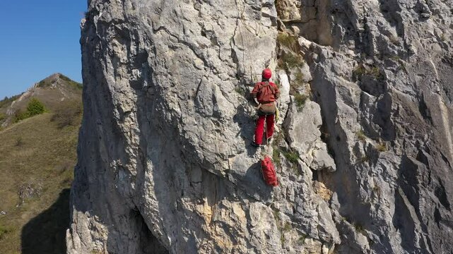 Aerial view of mountain rescuer doing rescue operations hanging on a rope